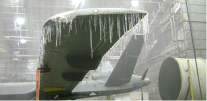 Protector aircraft being tested in a cold environment within a hangar. Ice forms on its wing.